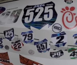 Collage-of-vinyl-decals-displayed-on-a-race-car